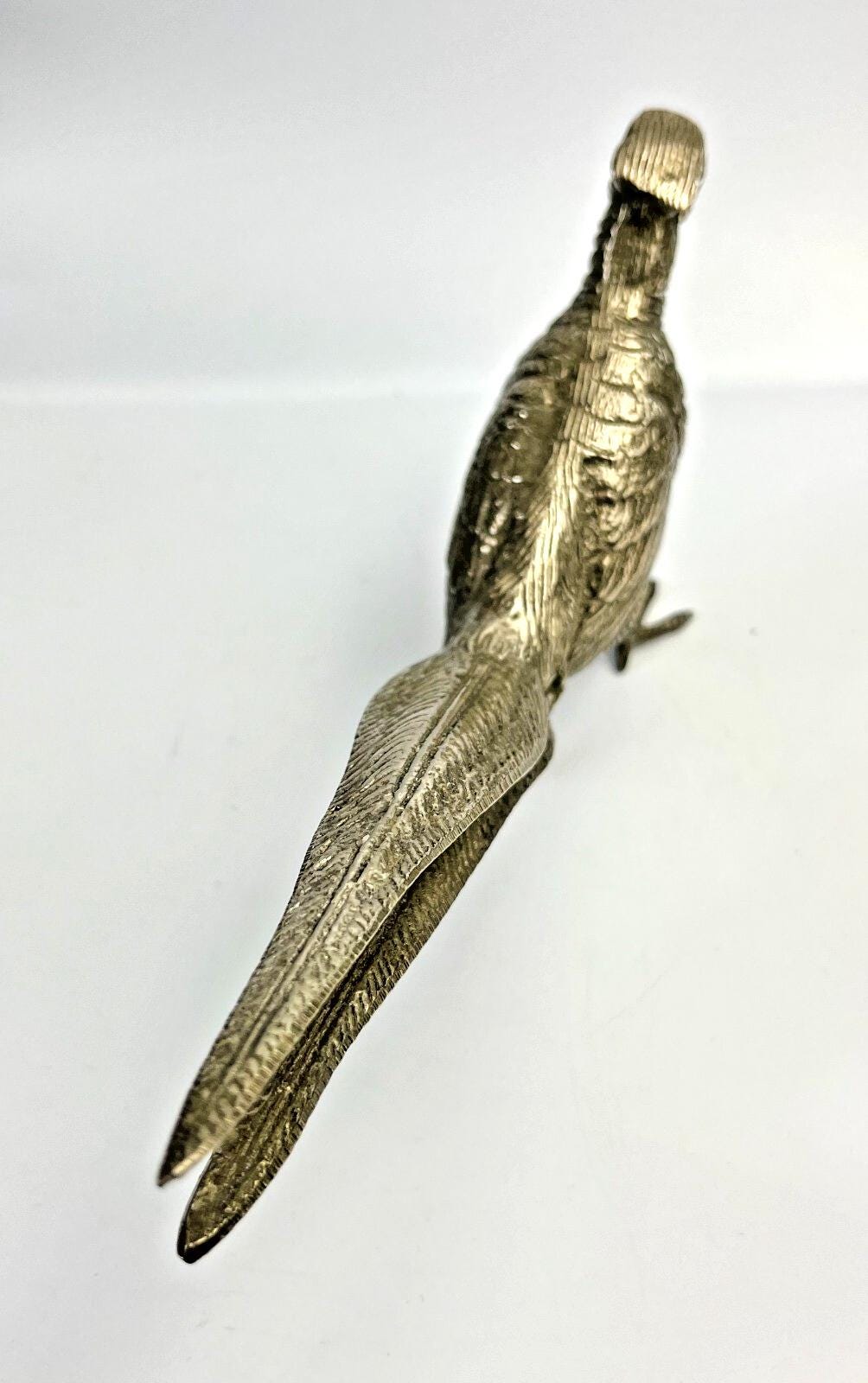 Antique pheasant cock bird in a heavy metal. bird sculpture pheasant sculpture