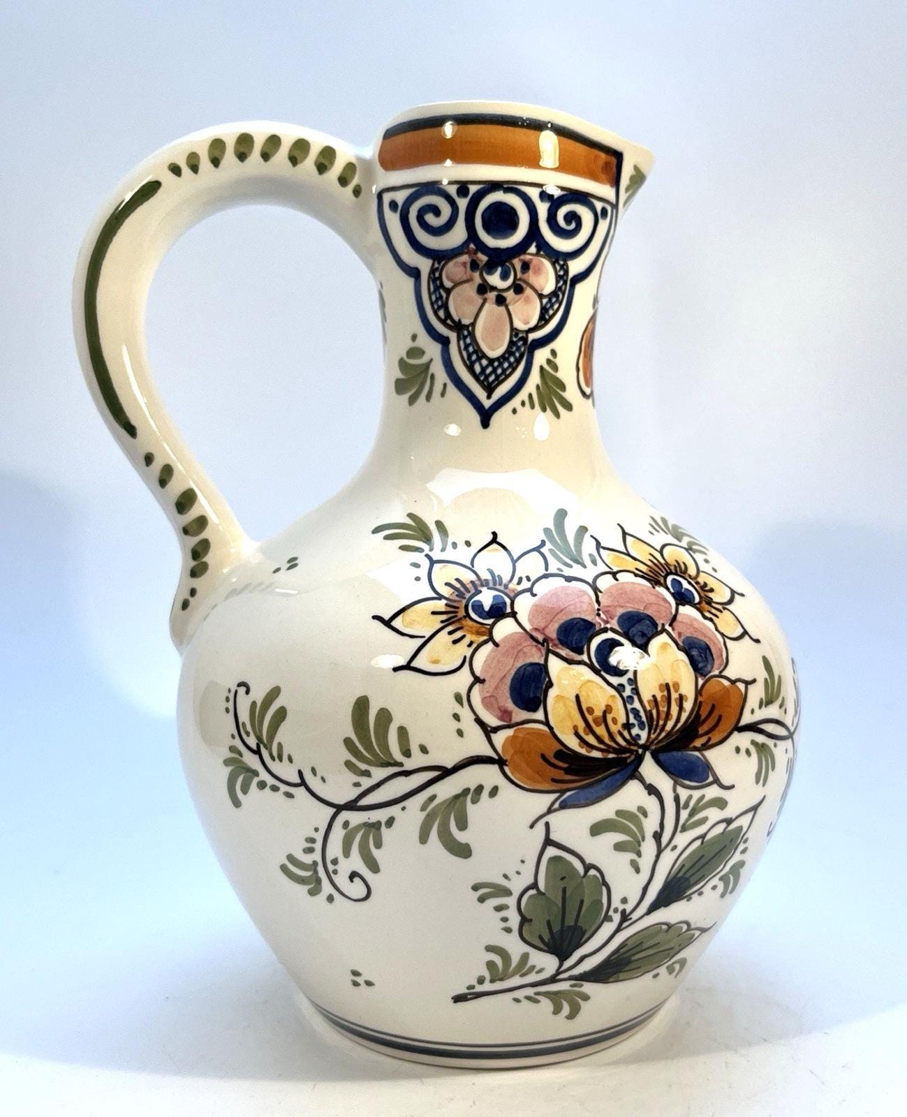 Vintage delft pottery jug in colourful hand painted windmill art and folk art
