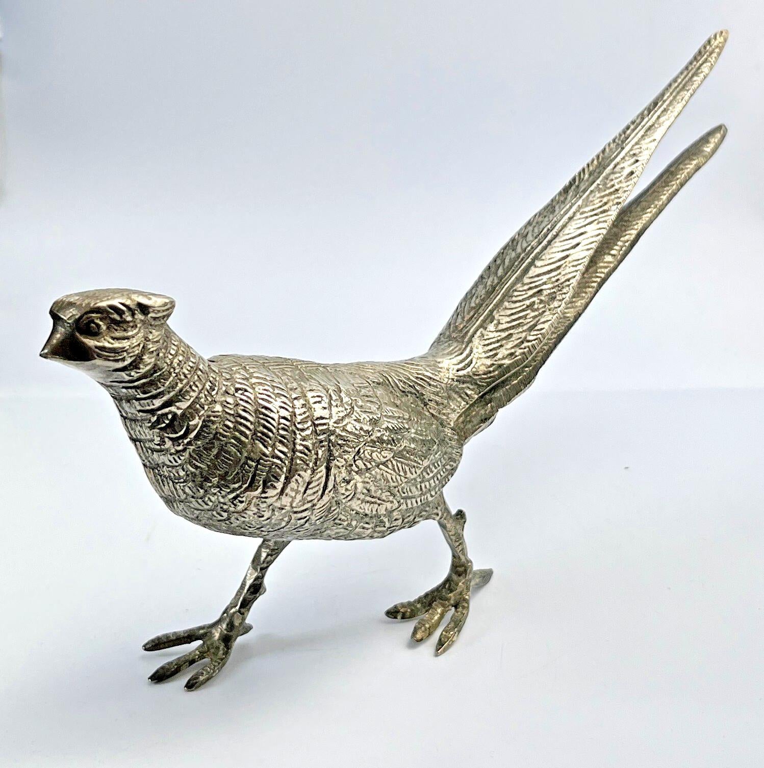 Antique pheasant cock bird in a heavy metal. bird sculpture pheasant sculpture