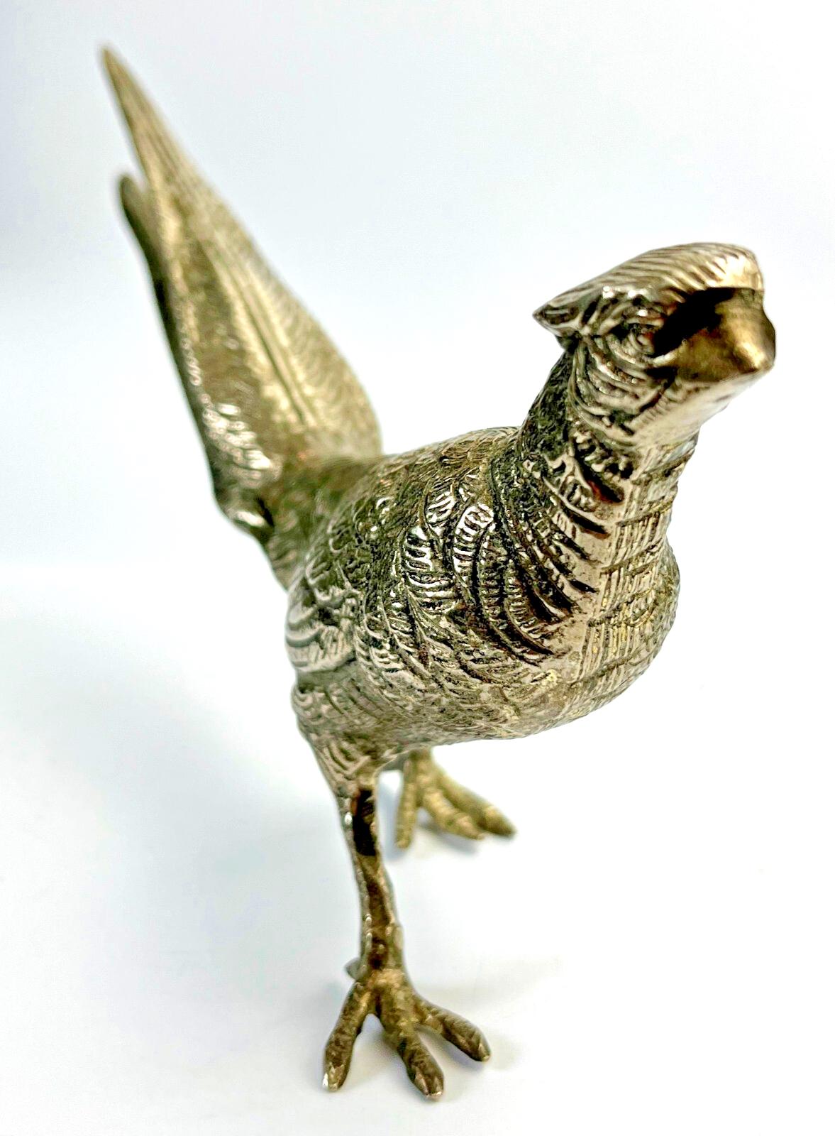 Antique pheasant cock bird in a heavy metal. bird sculpture pheasant sculpture