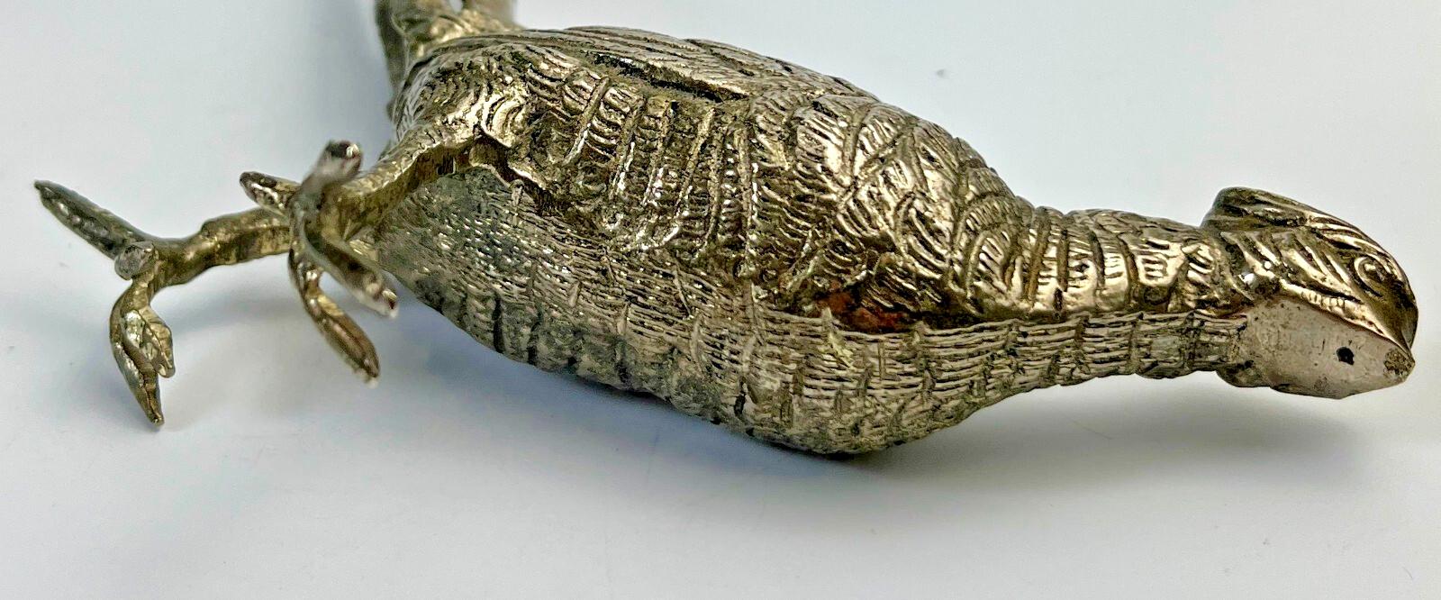 Antique pheasant cock bird in a heavy metal. bird sculpture pheasant sculpture