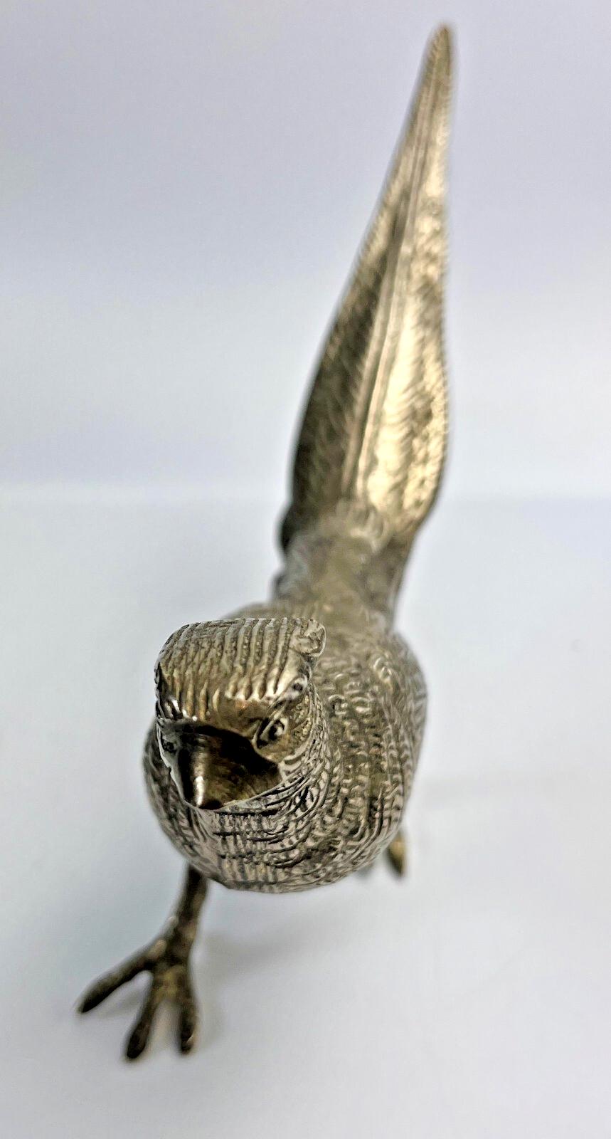 Antique pheasant cock bird in a heavy metal. bird sculpture pheasant sculpture