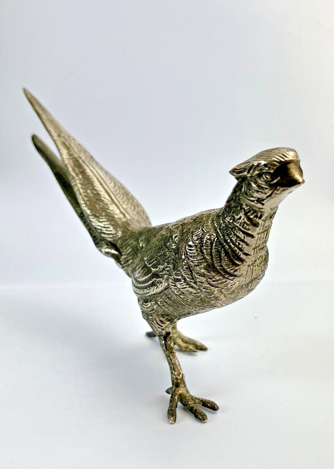 Antique pheasant cock bird in a heavy metal. bird sculpture pheasant sculpture