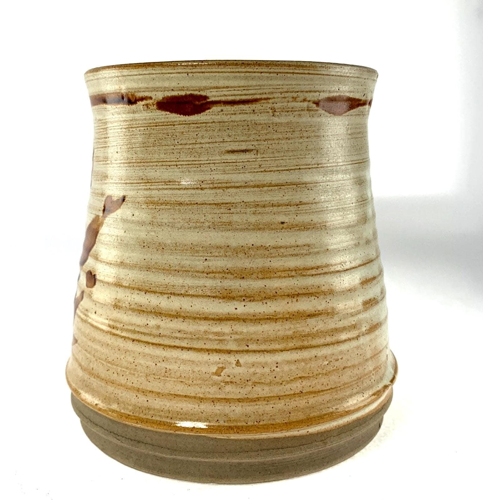 Mid century studio pottery vase with hand painted floral decoration on beige
