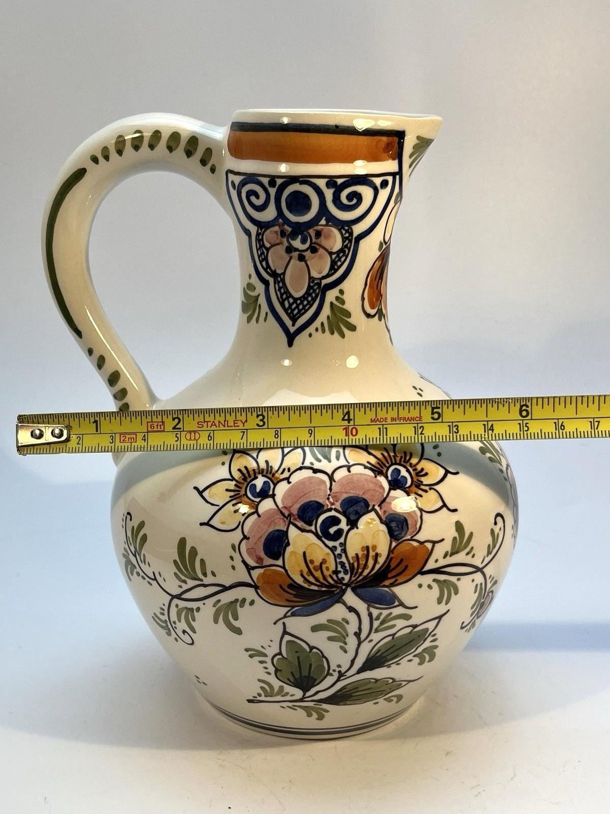 Vintage delft pottery jug in colourful hand painted windmill art and folk art