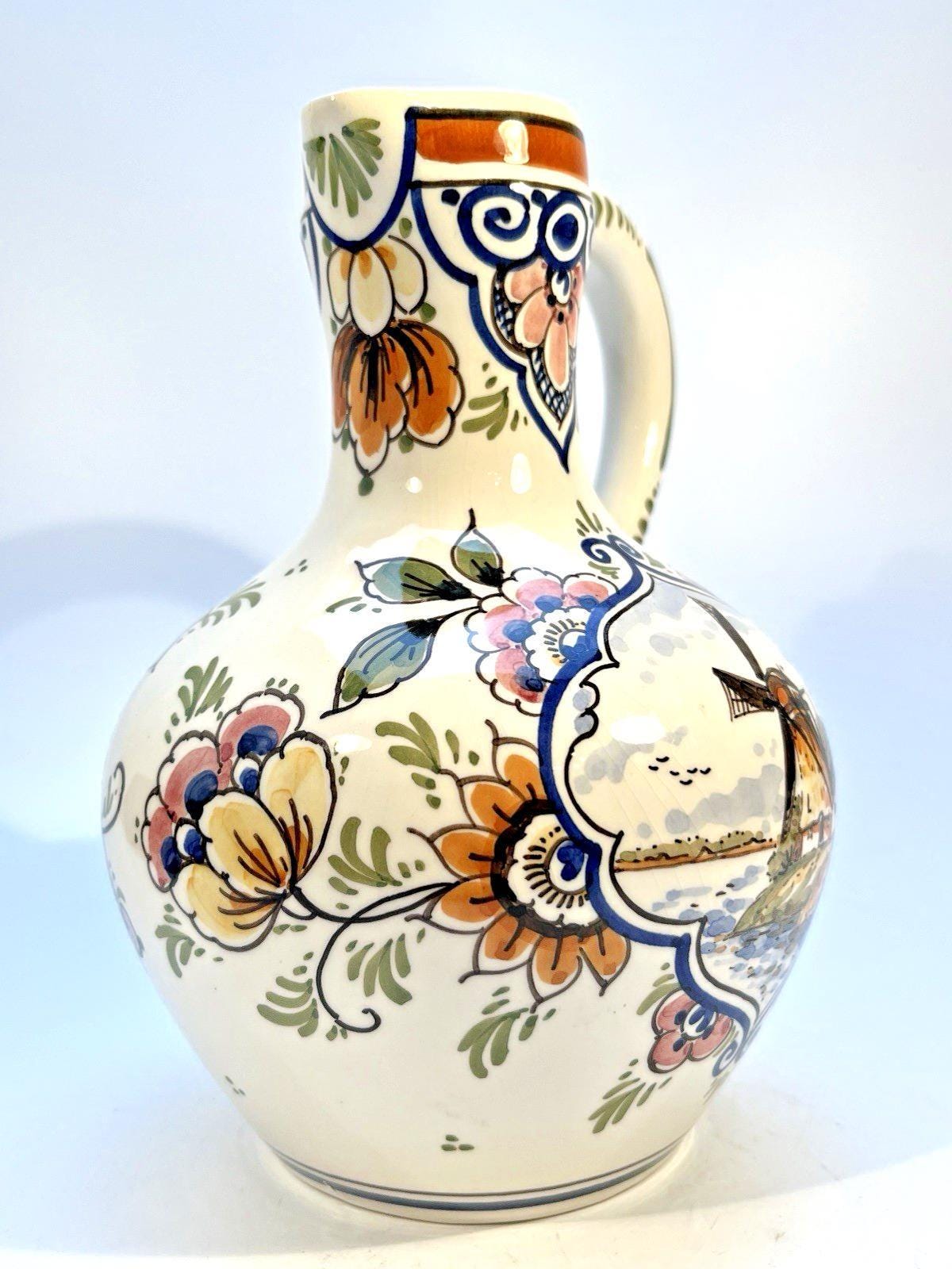 Vintage delft pottery jug in colourful hand painted windmill art and folk art