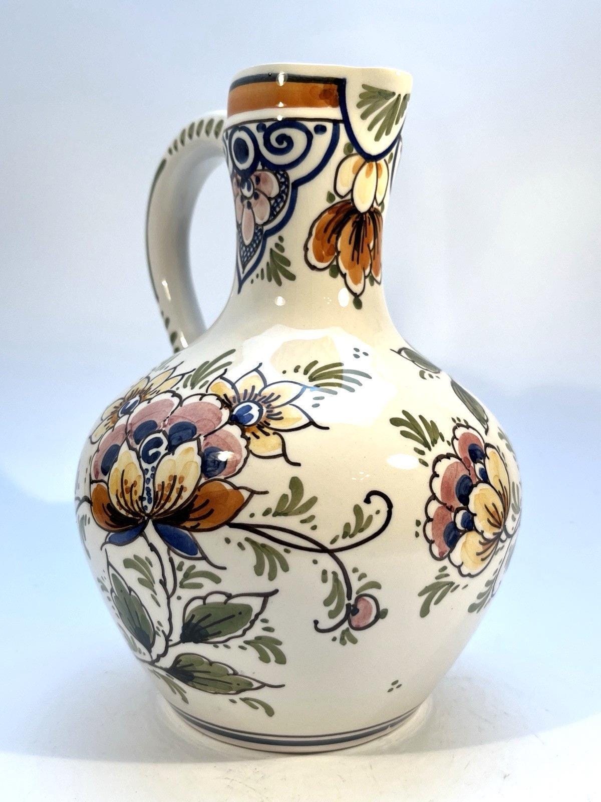 Vintage delft pottery jug in colourful hand painted windmill art and folk art