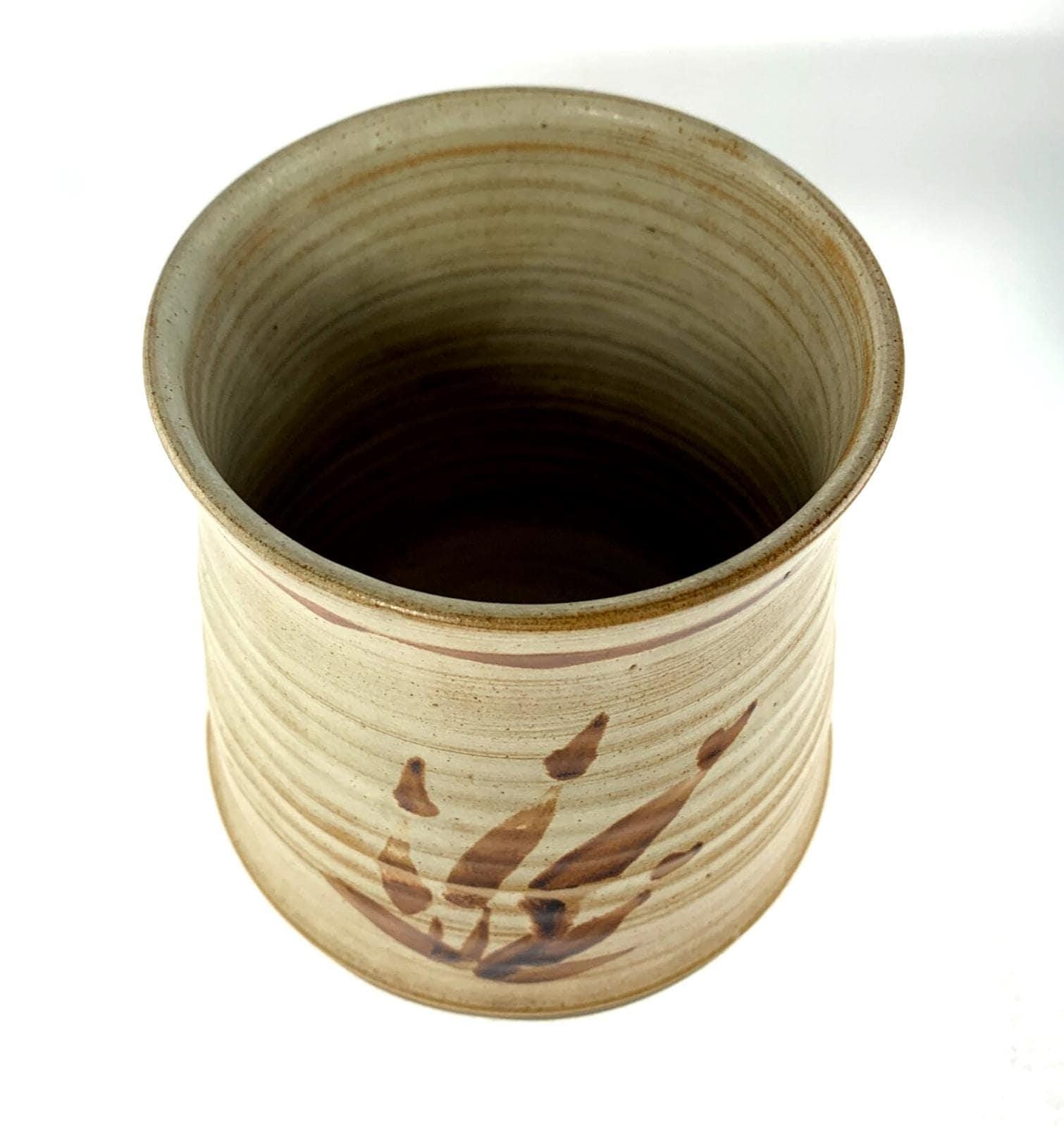 Mid century studio pottery vase with hand painted floral decoration on beige