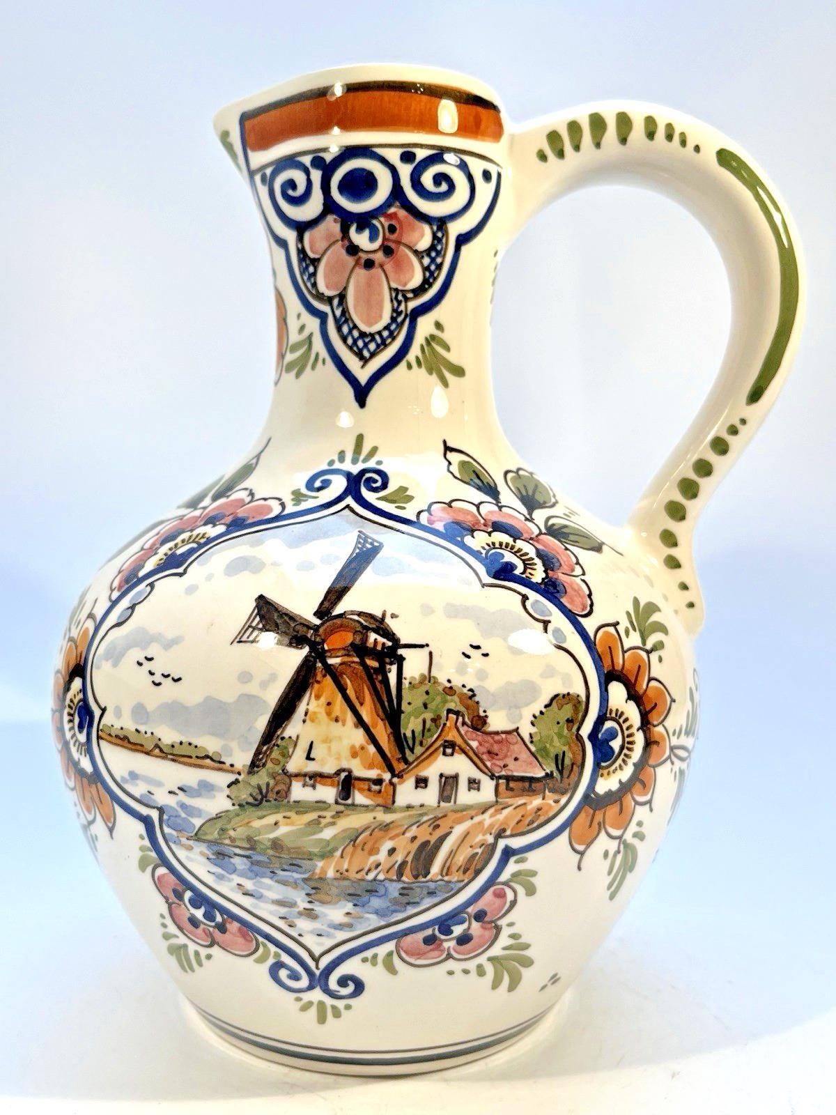 Vintage delft pottery jug in colourful hand painted windmill art and folk art