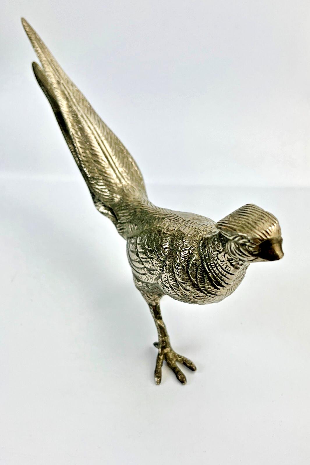 Antique pheasant cock bird in a heavy metal. bird sculpture pheasant sculpture