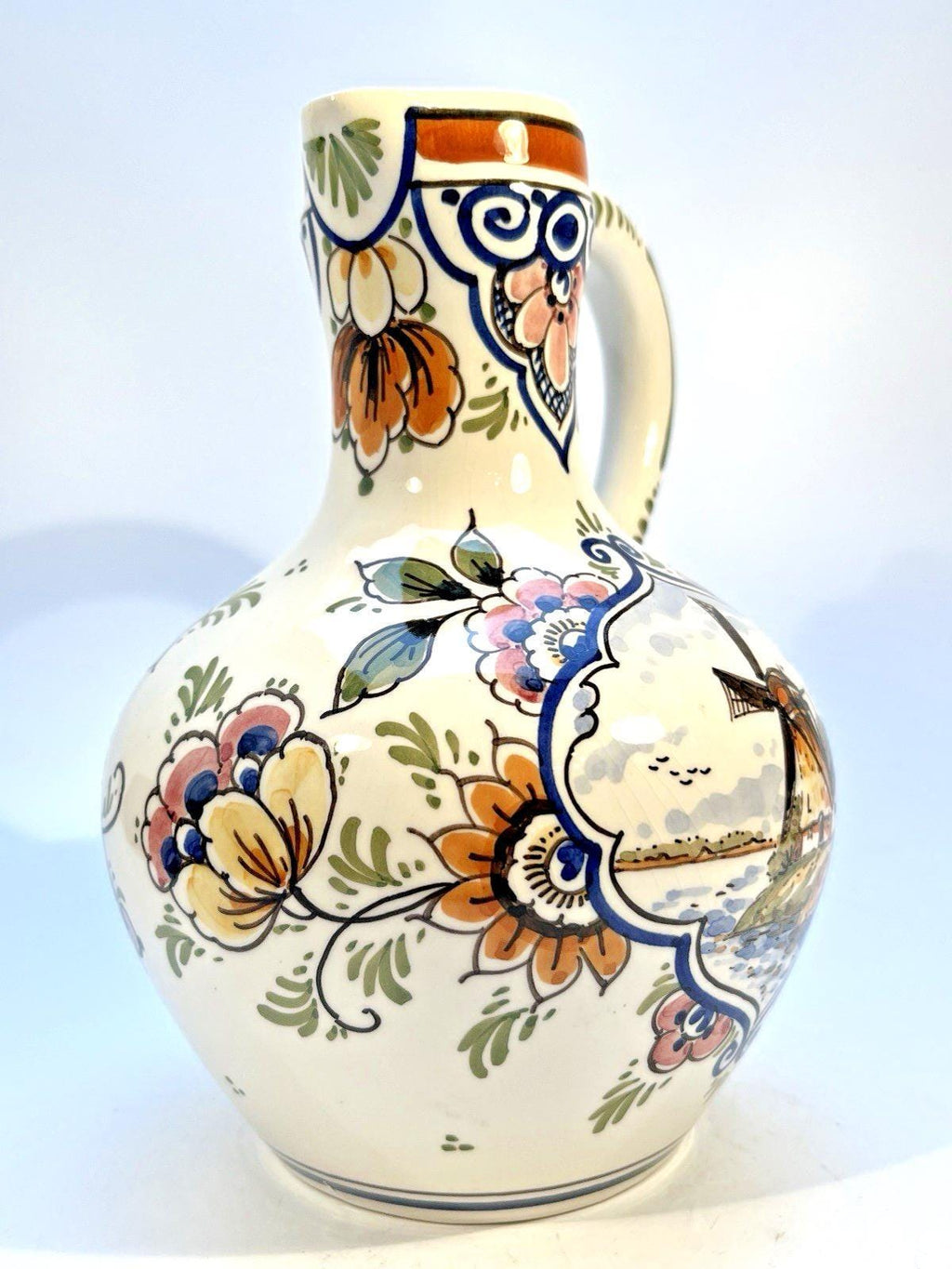 Vintage delft pottery jug in colourful hand painted windmill art and folk art